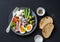 Healthy breakfast or snack - plate of canned tuna, green beans, mozzarella cheese, tomatoes, boiled egg, olives, grilled bread a d