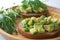 Healthy  breakfast toasted rye bread with avocado, arugula, lemon juice, salt and pepper