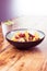 Healthy breakfast on wooden table - water with lemon and porridge with fruit and honey