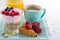 Healthy breakfast with yoghurt, berries, juice, toast and coffee