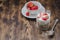Healthy breakfast. Yogurt, fresh strawberry,  spoon with the scattered granule on a wooden table. Copyspace