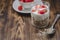 Healthy breakfast. Yogurt, fresh strawberry,  spoon with the scattered granule on a wooden table. Copyspace