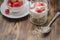 Healthy breakfast. Yogurt, fresh strawberry,  spoon with the scattered granule on a wooden table. Copyspace