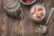 Healthy breakfast. Yogurt, fresh strawberry,  spoon with the scattered granule on a wooden table. Copyspace, top view