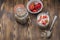 Healthy breakfast. Yogurt, fresh strawberry,  spoon with the scattered granule on a wooden table. Copyspace, top view