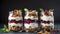 Healthy breakfast with yogurt, granola and berries in glass jars on dark background Generative AI