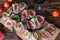 Healthy bruschettas with bread, cream cheese, prosciutto, figs and basil on rustic wooden table