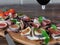 Healthy bruschettas with bread, cream cheese, prosciutto, figs and basil on rustic wooden table