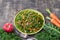 Healthy cabbage kale salad with carrots, apple and walnut on wooden background