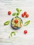 Healthy cabbage salad in bowl with tomatoes, top view