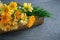 Healthy calendula or marigold flowers. Medicinal herbs in wooden crate