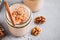 Healthy carrot cake smoothie with walnuts, cinnamon and chia seeds in glass jars