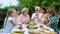 Healthy cheerful family drinking vitaminized fresh juice, celebrating traditions