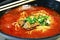 Healthy Chinese Tomato Beef Noodle Soup in Large Bowl With A Pair of Chopsticks.