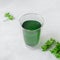Healthy chlorophyll drink on concrete grey background.