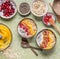 Healthy clean breakfast with smoothie bowl with mango and tropical fruits , chia seeds yogurt pudding and cranberries, nuts,