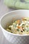 Healthy coleslaw salad with cabbage, carrots, dill and white dressing sauce