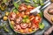 Healthy colorful tomatoes salad with cutlery , top view