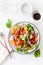 Healthy colorful vegan tomato salad with cucumber, radish, onion