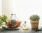 Healthy colorful vegetables in metal basket, olive oil, potted thyme and kitchen utensils on grey kitchen counter at window
