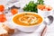 Healthy comfort pumpkin, butternut squash soup in white bowl. Autumn Winter food