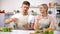 Healthy couple preparing to drink fresh spirulina smoothie, vegetarian lifestyle