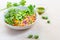 Healthy couscous salad with edamame beans, rucola and cucamelon