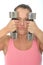 Healthy Crazy Young Woman Holding Dumb Bell Weights and Pulling Silly Facial Expression