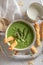 Healthy creamy asparagus soup with sesame seeds and grissini