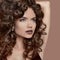 Healthy curly hair. Beauty Makeup. Brunette girl model with fash