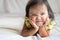 Healthy cute little asian girl toddler smiling on bed.