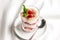 Healthy dessert in glass with fresh strawberries and cream yogurt