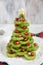 Healthy dessert idea for kids party - funny edible kiwi pomegranate Christmas tree