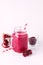 Healthy Detox Smoothies on a White Background With Berry and Pomegranate Glass Jar of Tasty Smoothie Vertical