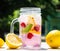 Healthy detox water served in a mason jar with ice lemon raspberries mint leaf bubbles and surrounded with green nature and trees