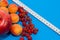 Healthy diet composition, tape measure, raspberries, apricots, apple and red currants