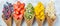 Healthy diet concept - fruits and frozen berries in ice cream cones on rustic background