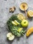 Healthy diet concept. Smoothie detox drink ingredients - kale, apple, banana, honey, ginger, lemon on a grey background, top view