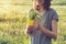 Healthy diet, happy young smiling slim girl holding yellow cup with fresh green grass