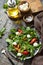 Healthy diet salad with arugula, mozzarella, mussels and vinaigrette dressing on a wooden table. Low calories keto dieting meal