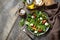 Healthy diet salad with arugula, mozzarella, mussels and vinaigrette dressing on a wooden table. Low calories keto dieting meal.