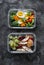 Healthy diet snack, breakfast lunch box on dark background, top view. Boiled egg, fresh vegetables and fruits - tasty healthy food