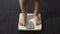 Healthy dieting, girl standing on bathroom scales to check weight, normal index