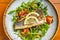 Healthy diner with sea bass fillet and vegetable salad, seabass fish. Orange background. Top view