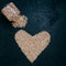 Healthy dried garbanzo or chickpeas spilled from glass jar, heart shaped organic raw beans isolated over black background. Living