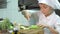 Healthy eating. Children cutting vegetable salad in the restaurant kitchen