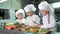 Healthy eating. Children cutting vegetable salad in the restaurant kitchen