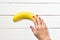 Healthy eating concept. Female hand holds a banana