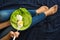 Healthy eating concept. Woman`s hands holding plate with lettuce, avocado slices and poached eggs