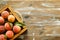 Healthy eating concept. Wooden tray fully stacked with local produce farm grown organic ripe peaches.